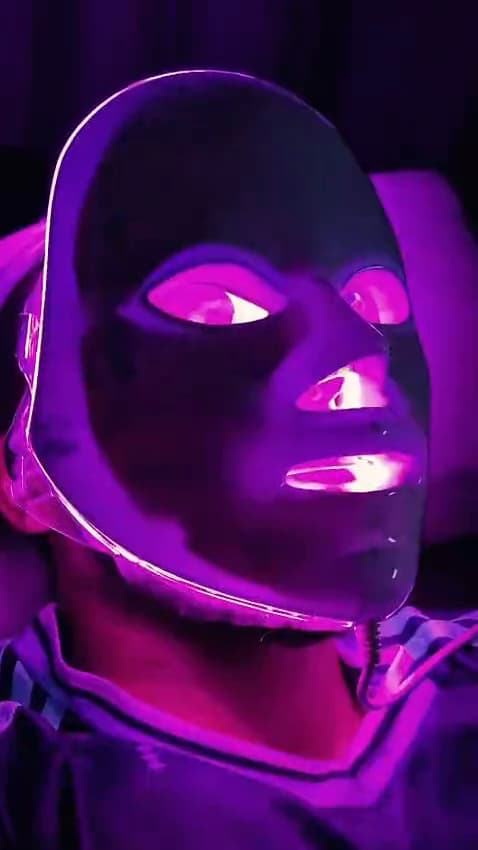 A clinical LED panel held over the skin during a session