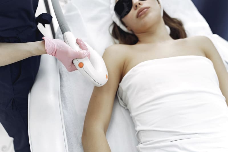 A contouring handpiece being worked across the skin