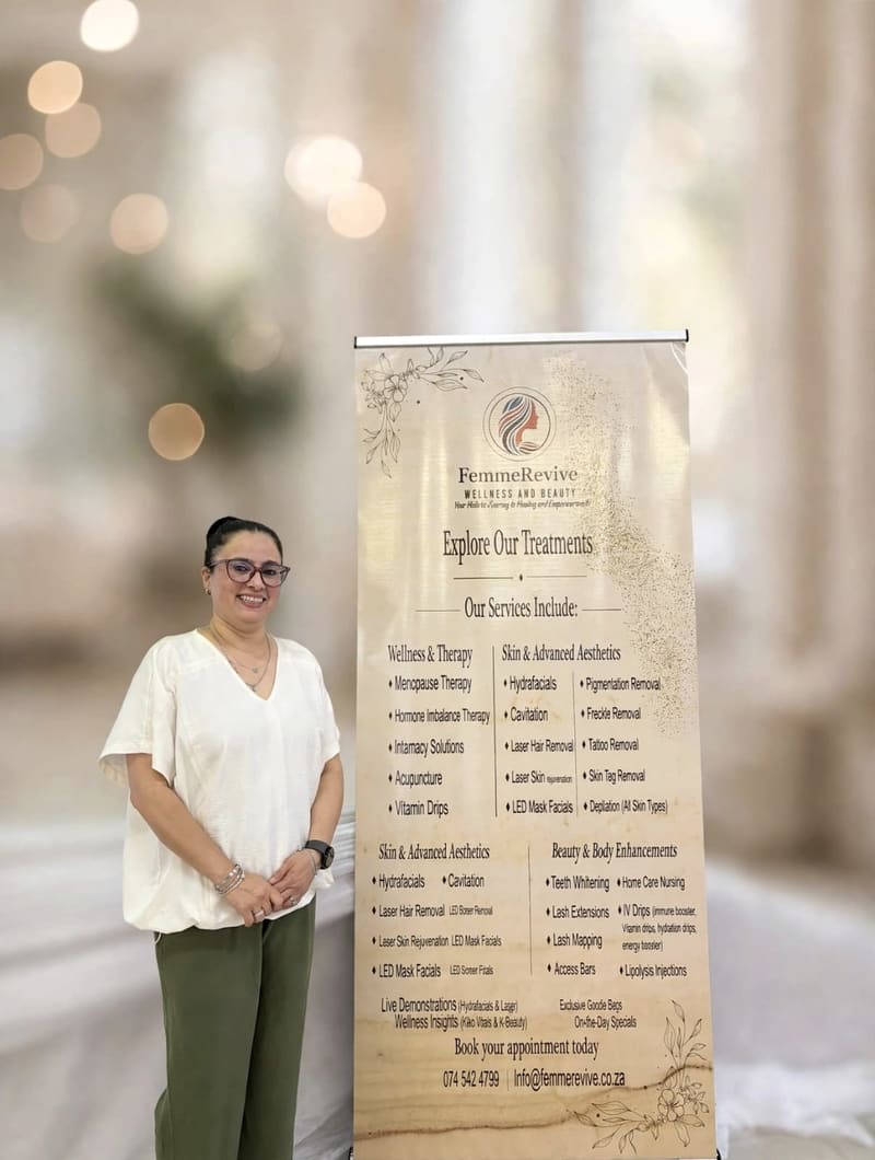 Shehnaaz Noorbhai standing beside the FemmeRevive banner